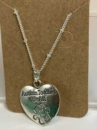 Silver necklace with Autism awareness message