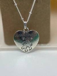 Silver necklace with Autism awareness message