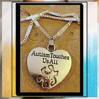 Silver necklace with Autism awareness message
