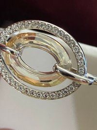 Authentic Swarovski Signed Logan Golden Shadow Bangle Bracelet and Rhodium-plated Circles Masquerade Pendant Pierced Earrings set.