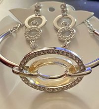 Authentic Swarovski Signed Logan Golden Shadow Bangle Bracelet and Rhodium-plated Circles Masquerade Pendant Pierced Earrings set.