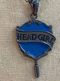 Head Girl pendant on black necklace