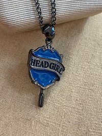 Head Girl pendant on black necklace