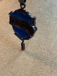 Head Girl pendant on black necklace