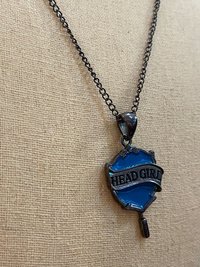 Head Girl pendant on black necklace