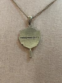 Head Girl pendant on black necklace