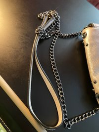 Bejeweled  Juicy Couture white with silver tone chain and dark stone