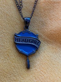 Head Girl pendant on black necklace