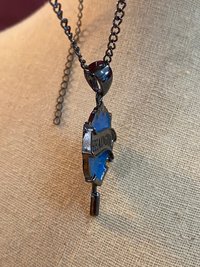 Head Girl pendant on black necklace