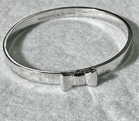 Silver tone Kate Spade “Take a Bow” bangle bracelet