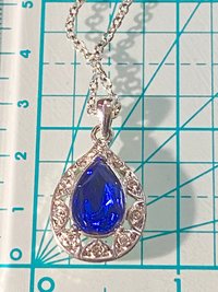 Vintage blue teardrop crystal halo NRT signed pendant on a silver chain with matching dangle earrings.