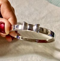 Silver tone Kate Spade “Take a Bow” bangle bracelet