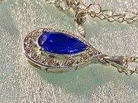 Vintage blue teardrop crystal halo NRT signed pendant on a silver chain with matching dangle earrings.
