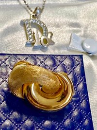 Vintage Gold tone 1980s Christian Dior high polished and textured clip on earrings.