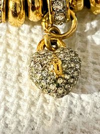 Juicy Couture Rhinestones pave pendant with Gold tone high gloss beads on black cord accent.