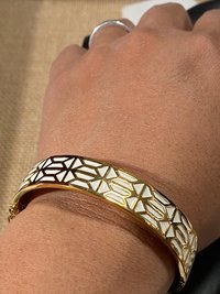 Gold tone with white enameled pattern Stella & Dot Bangle bracelet