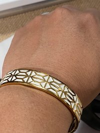 Gold tone with white enameled pattern Stella & Dot Bangle bracelet