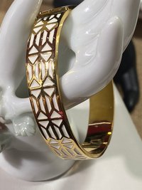 Gold tone with white enameled pattern Stella & Dot Bangle bracelet