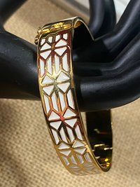 Gold tone with white enameled pattern Stella & Dot Bangle bracelet