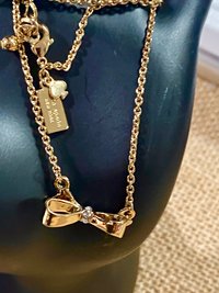 Kate Spade signed gold tone Bow pendant necklace