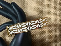 Gold tone with white enameled pattern Stella & Dot Bangle bracelet
