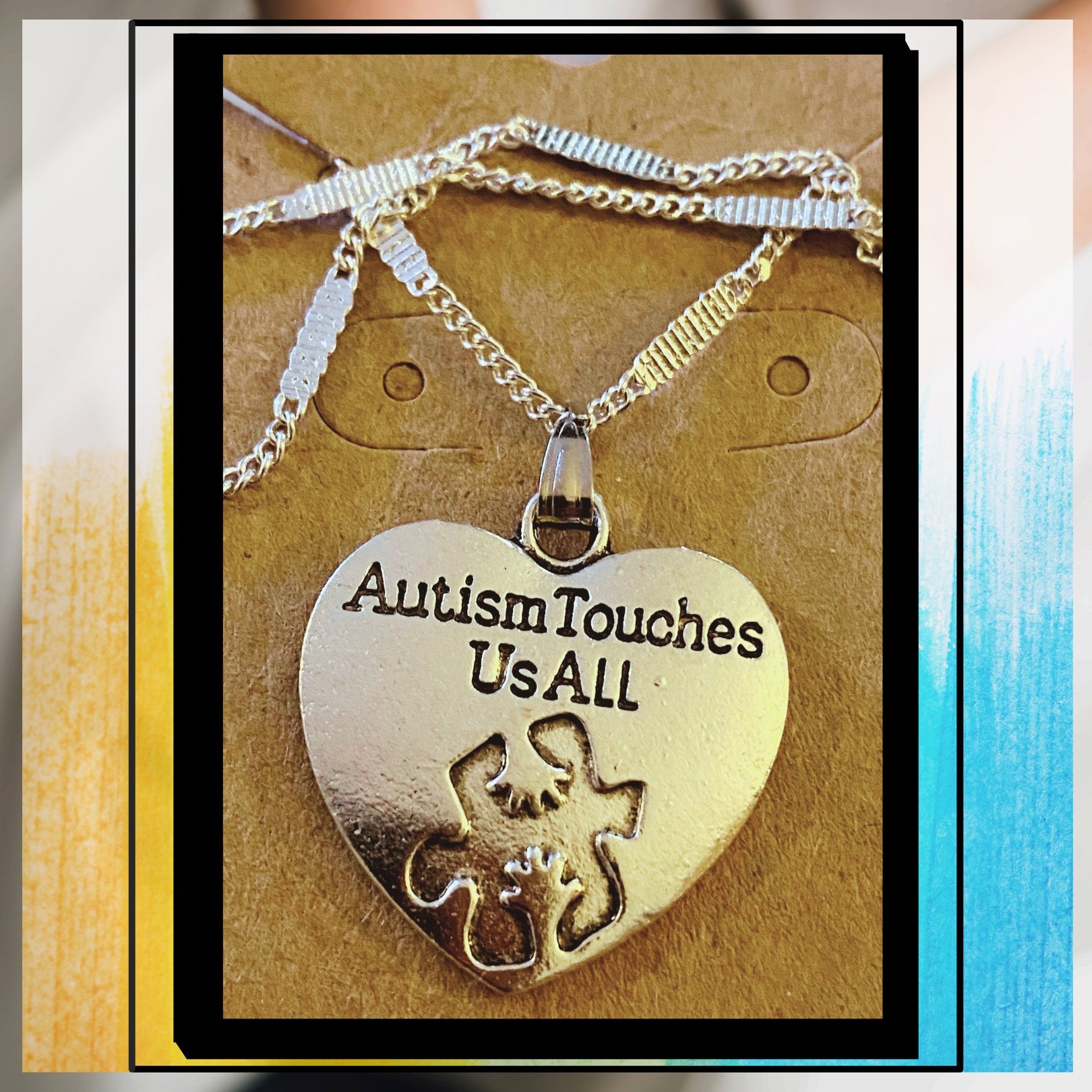 Silver necklace with Autism awareness message
