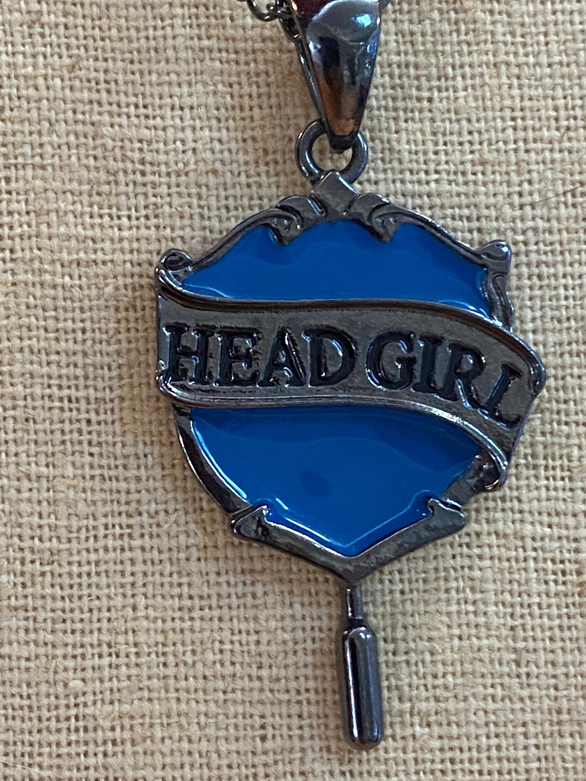 Head Girl pendant on black necklace