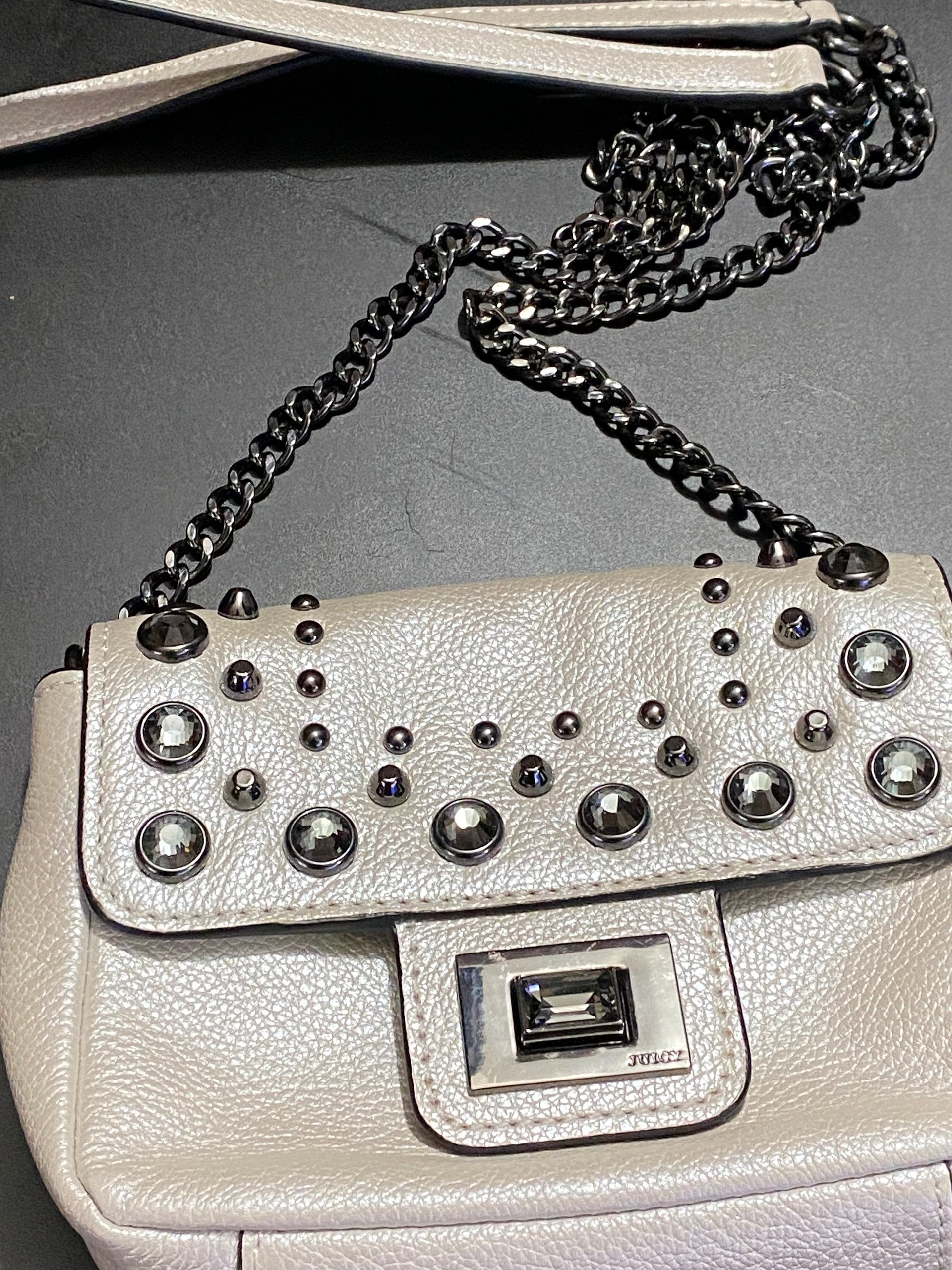 Bejeweled  Juicy Couture white with silver tone chain and dark stone
