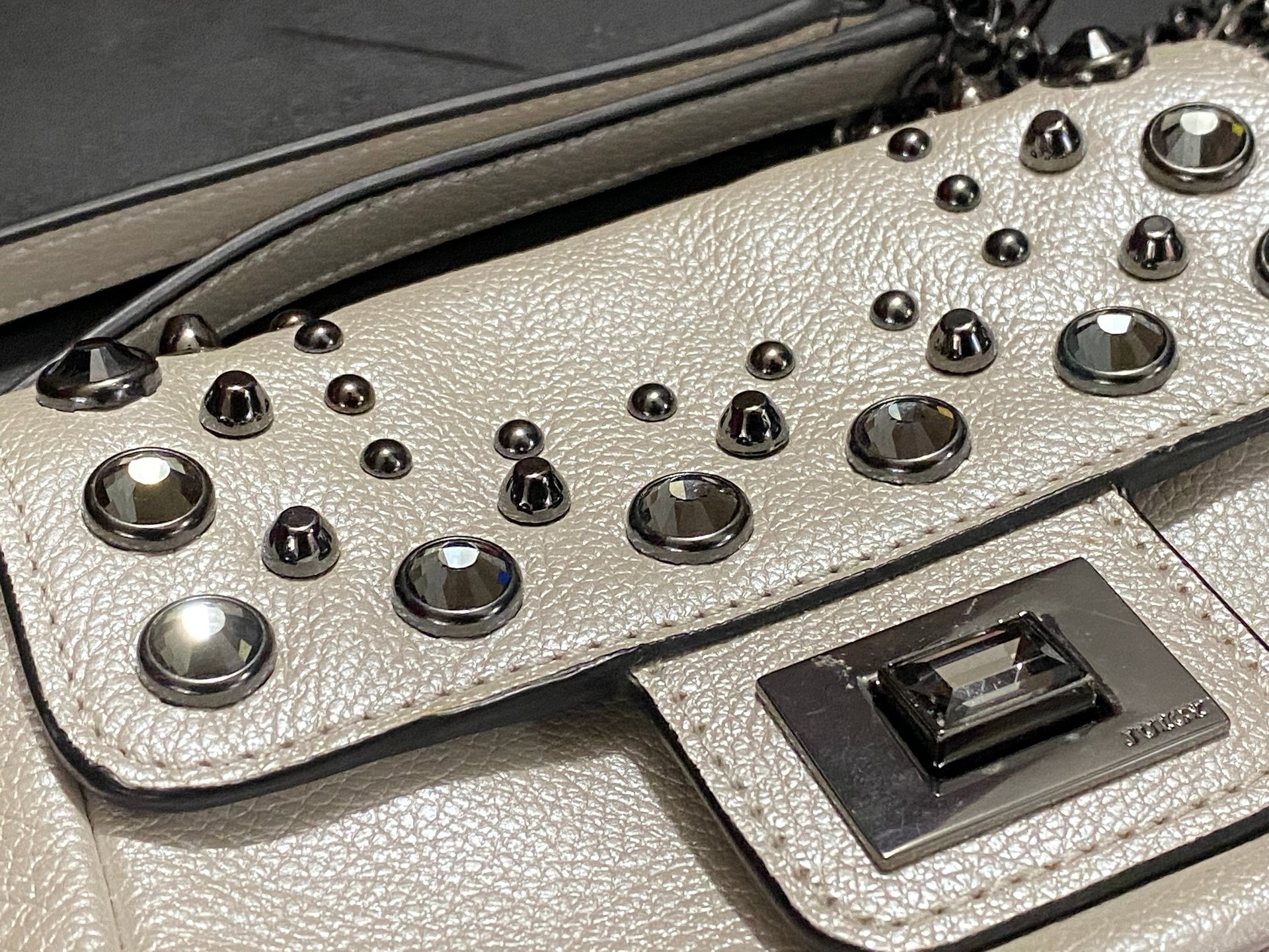 Bejeweled  Juicy Couture white with silver tone chain and dark stone