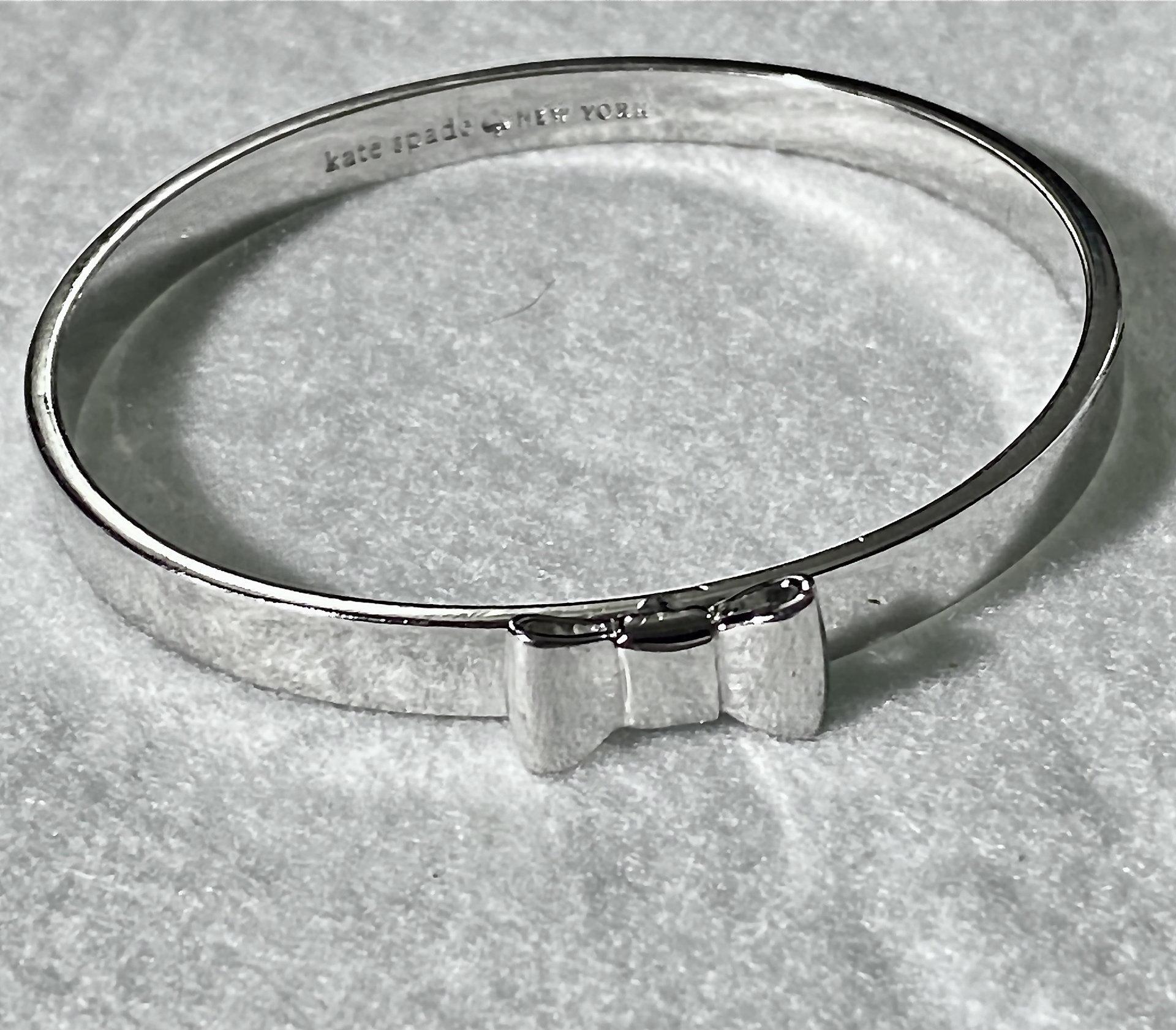 Silver tone Kate Spade “Take a Bow” bangle bracelet