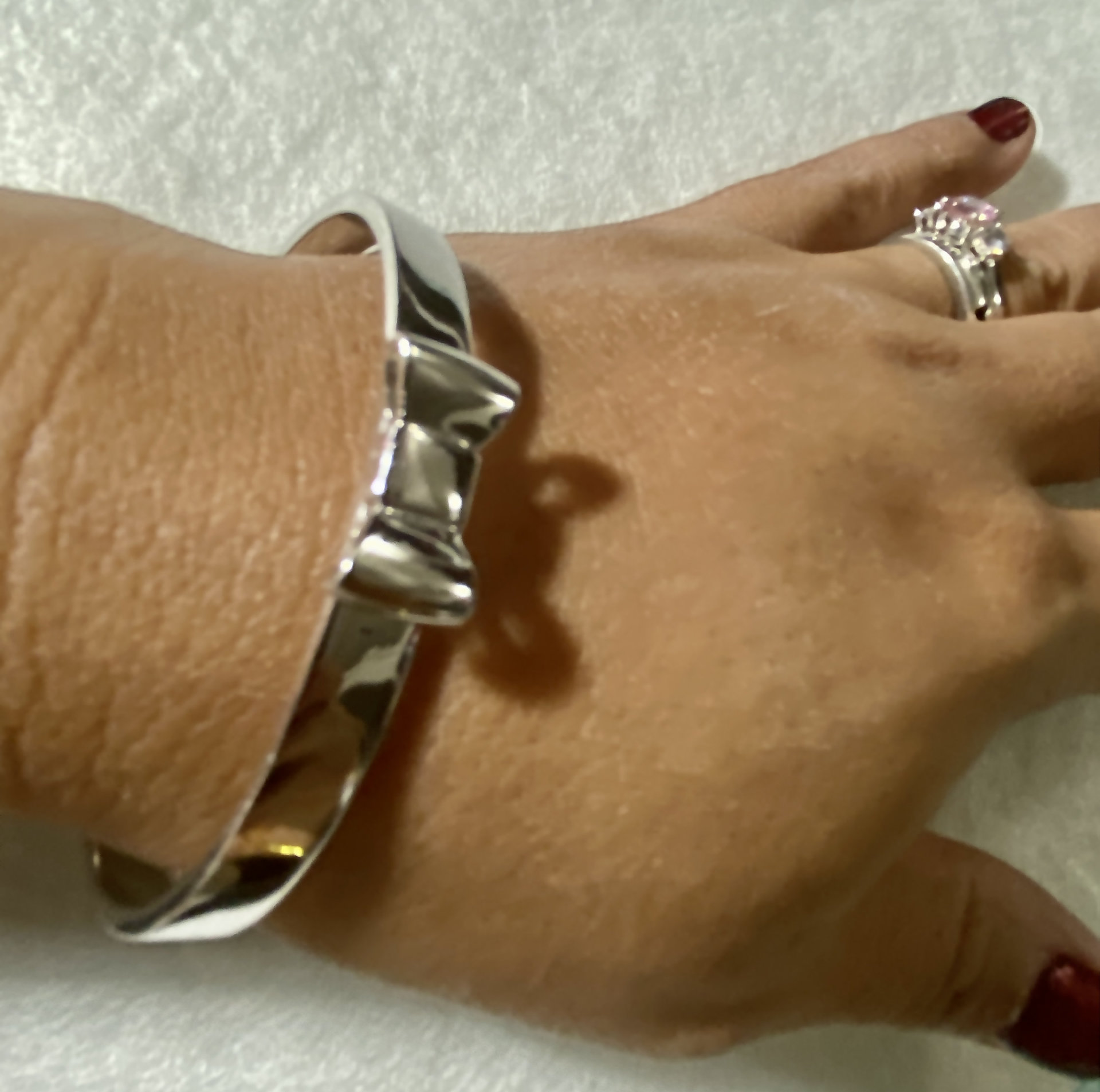 Silver tone Kate Spade “Take a Bow” bangle bracelet