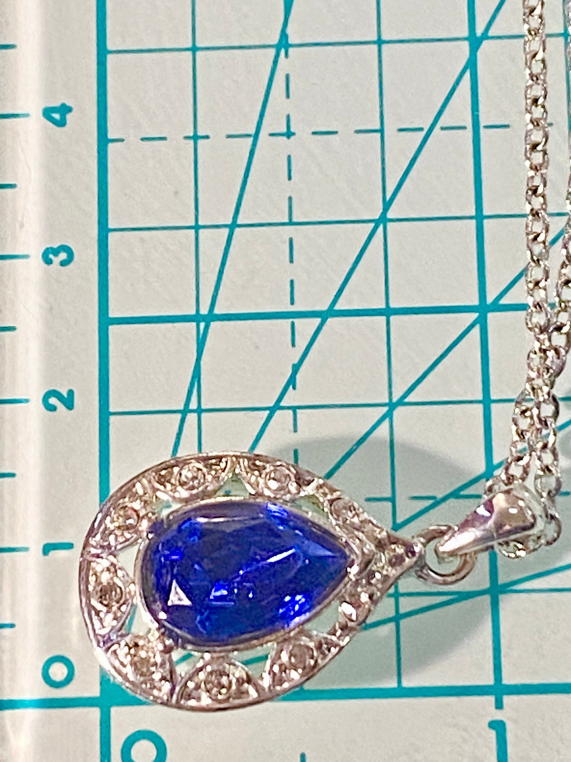 Vintage blue teardrop crystal halo NRT signed pendant on a silver chain with matching dangle earrings.