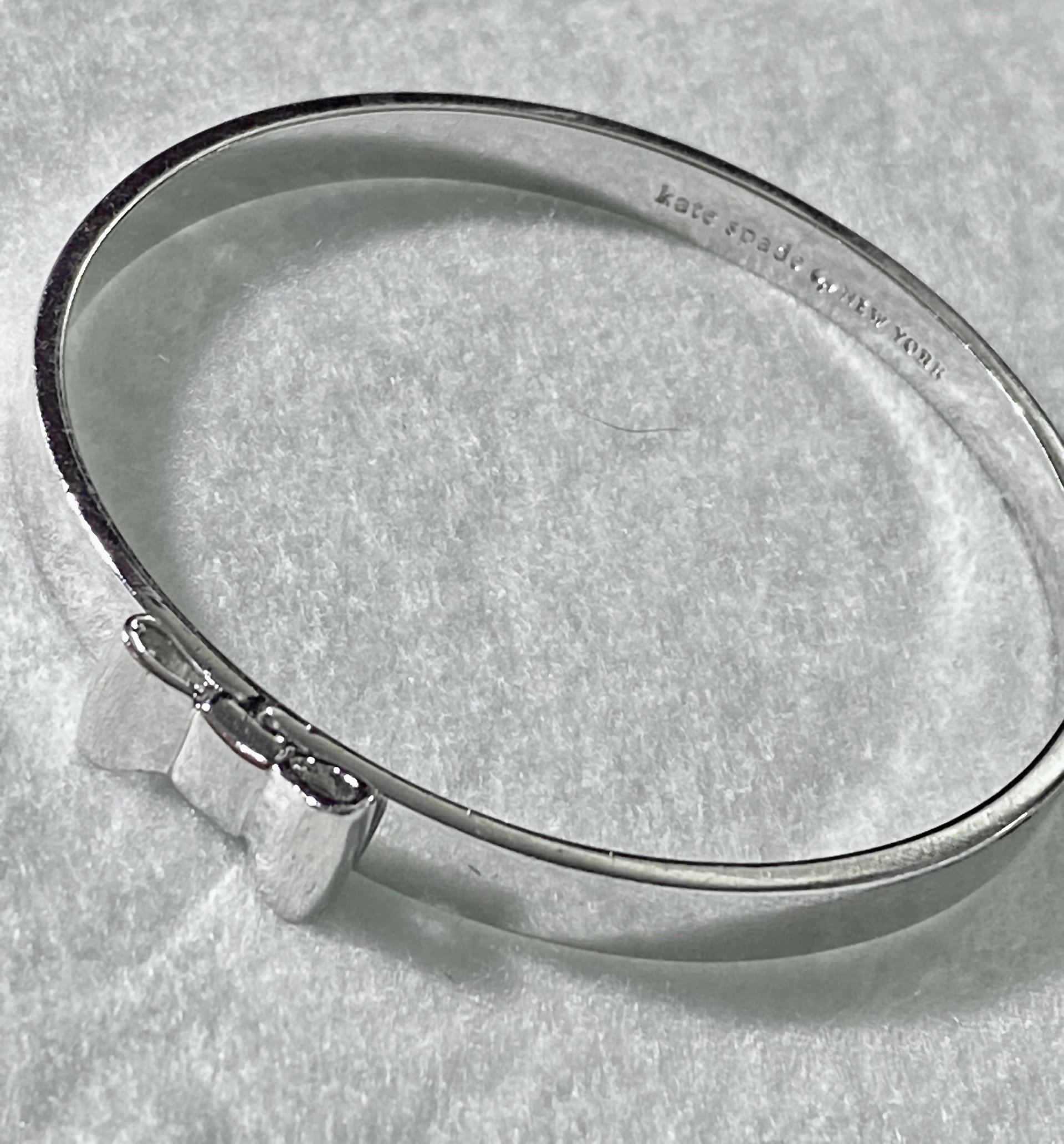 Silver tone Kate Spade “Take a Bow” bangle bracelet