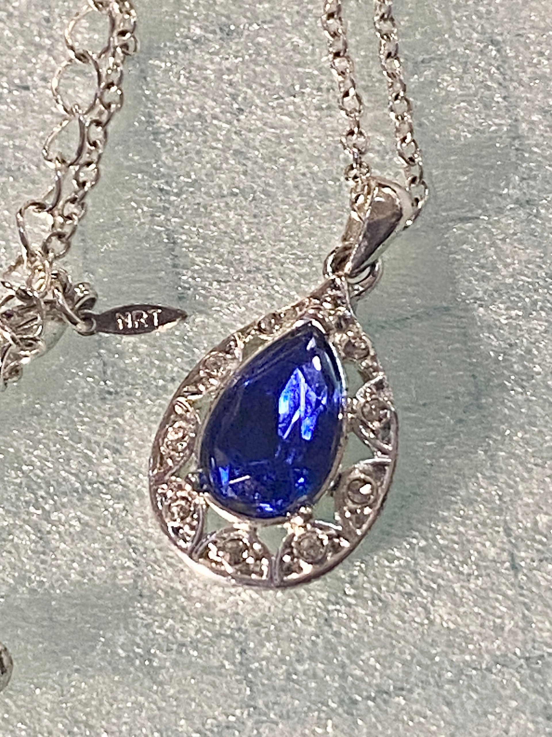 Vintage blue teardrop crystal halo NRT signed pendant on a silver chain with matching dangle earrings.