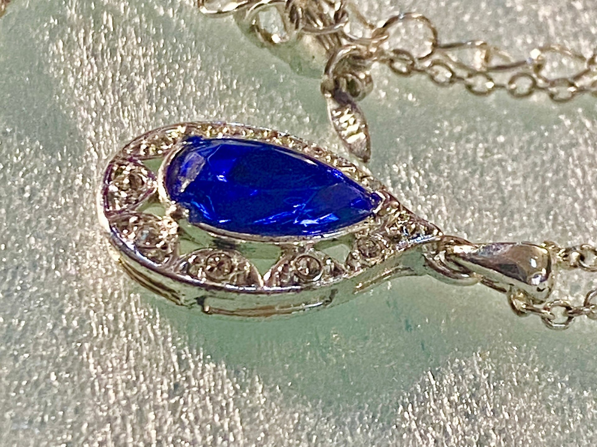 Vintage blue teardrop crystal halo NRT signed pendant on a silver chain with matching dangle earrings.