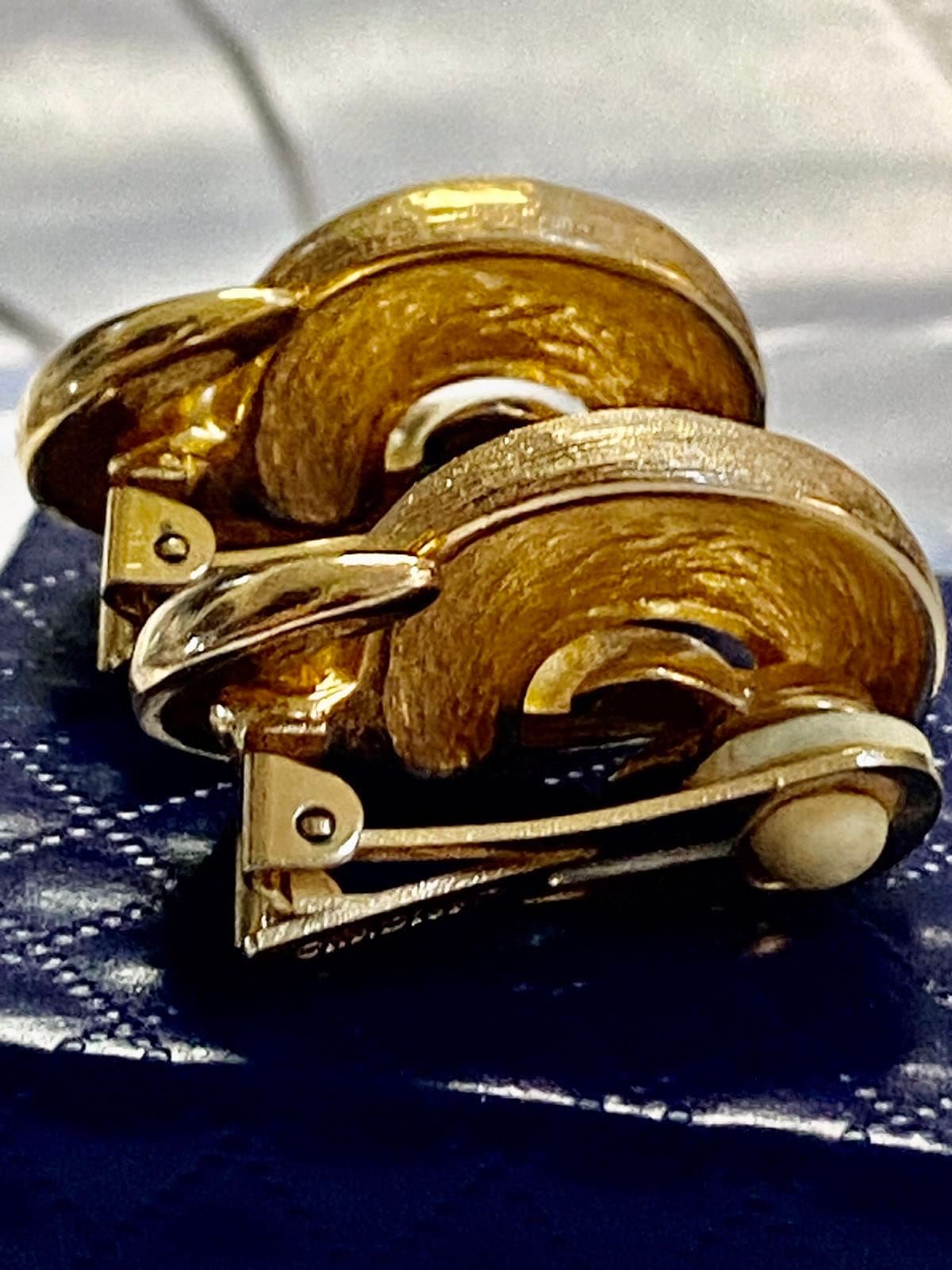Vintage Gold tone 1980s Christian Dior high polished and textured clip on earrings.