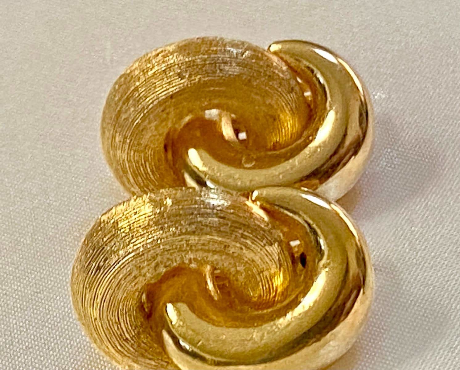 Vintage Gold tone 1980s Christian Dior high polished and textured clip on earrings.
