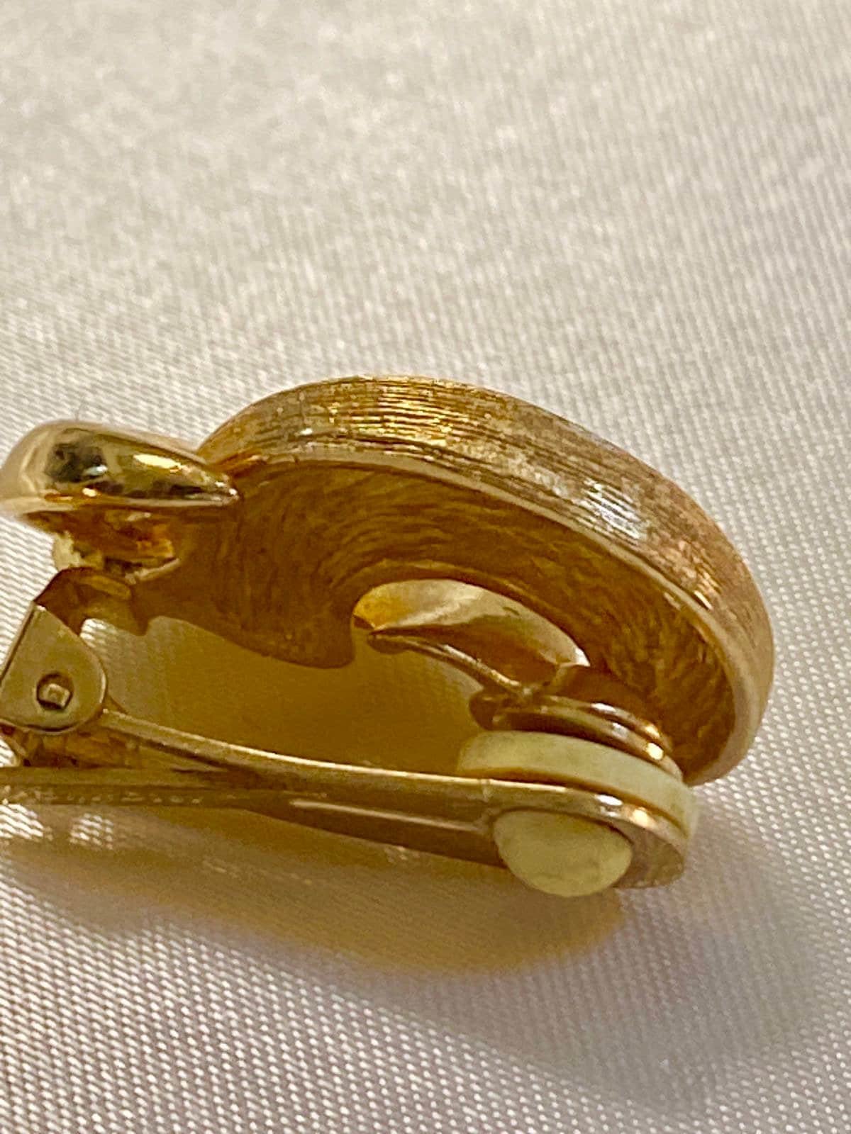 Vintage Gold tone 1980s Christian Dior high polished and textured clip on earrings.