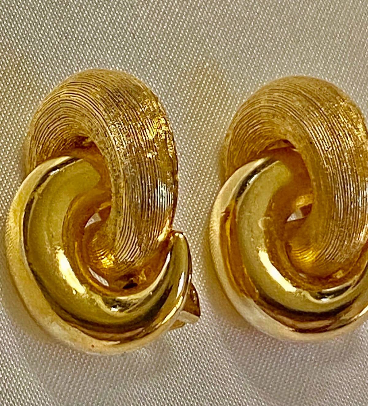 Vintage Gold tone 1980s Christian Dior high polished and textured clip on earrings.