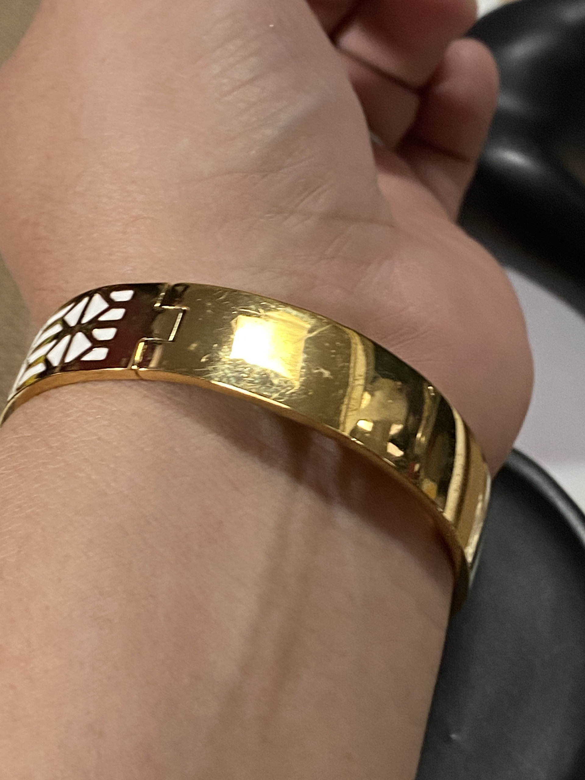 Gold tone with white enameled pattern Stella & Dot Bangle bracelet