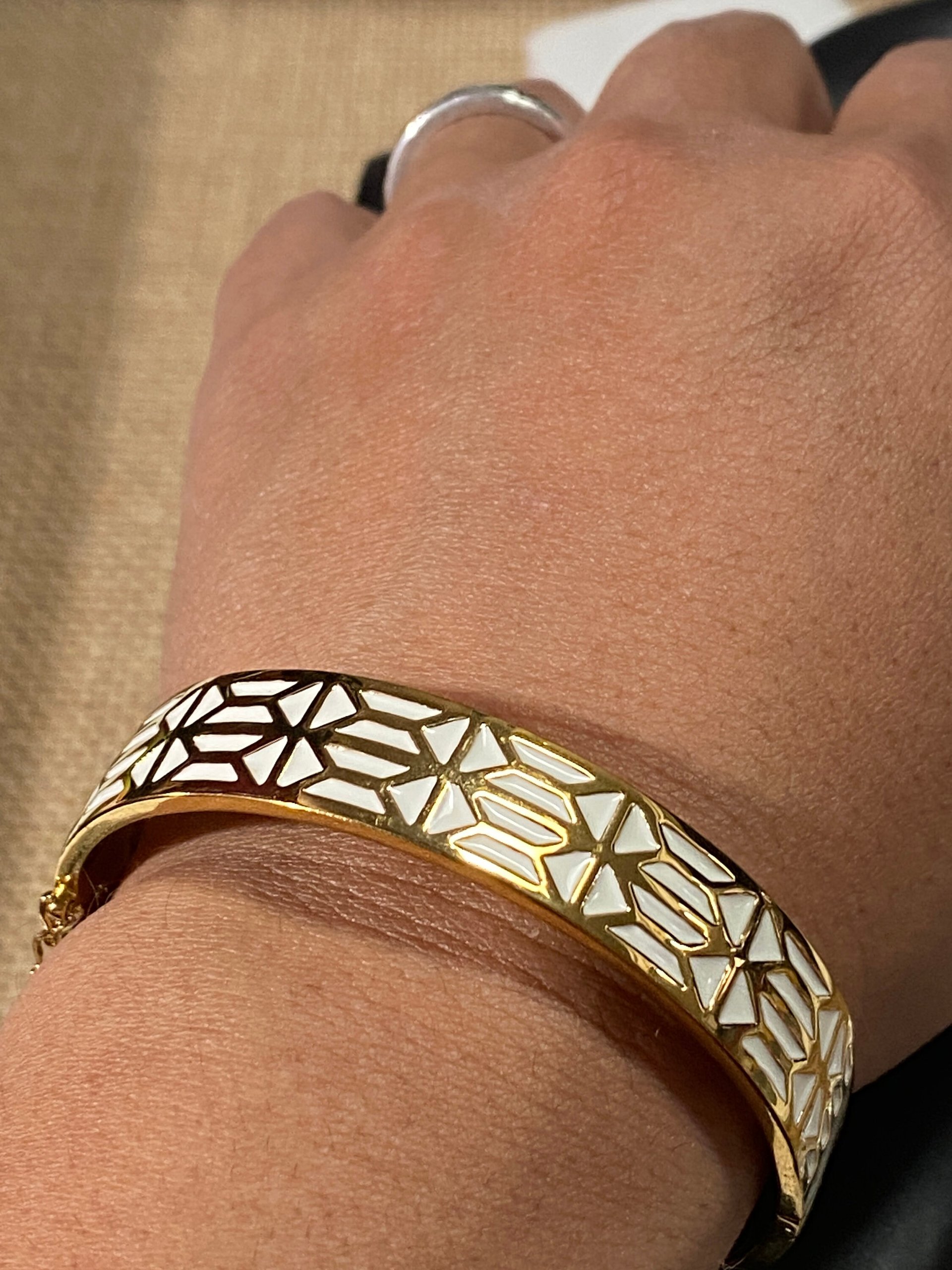 Gold tone with white enameled pattern Stella & Dot Bangle bracelet