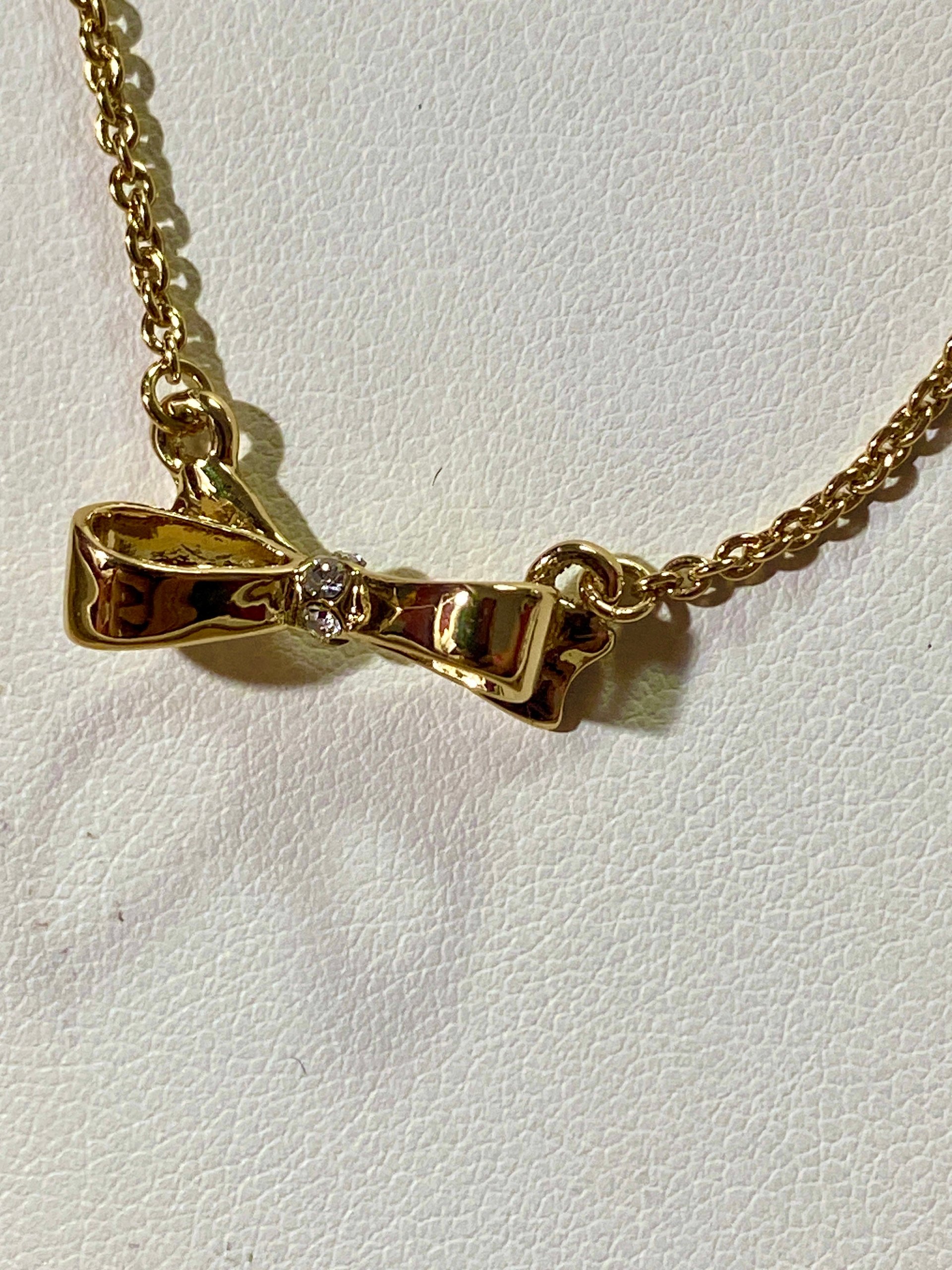 Kate Spade signed gold tone Bow pendant necklace
