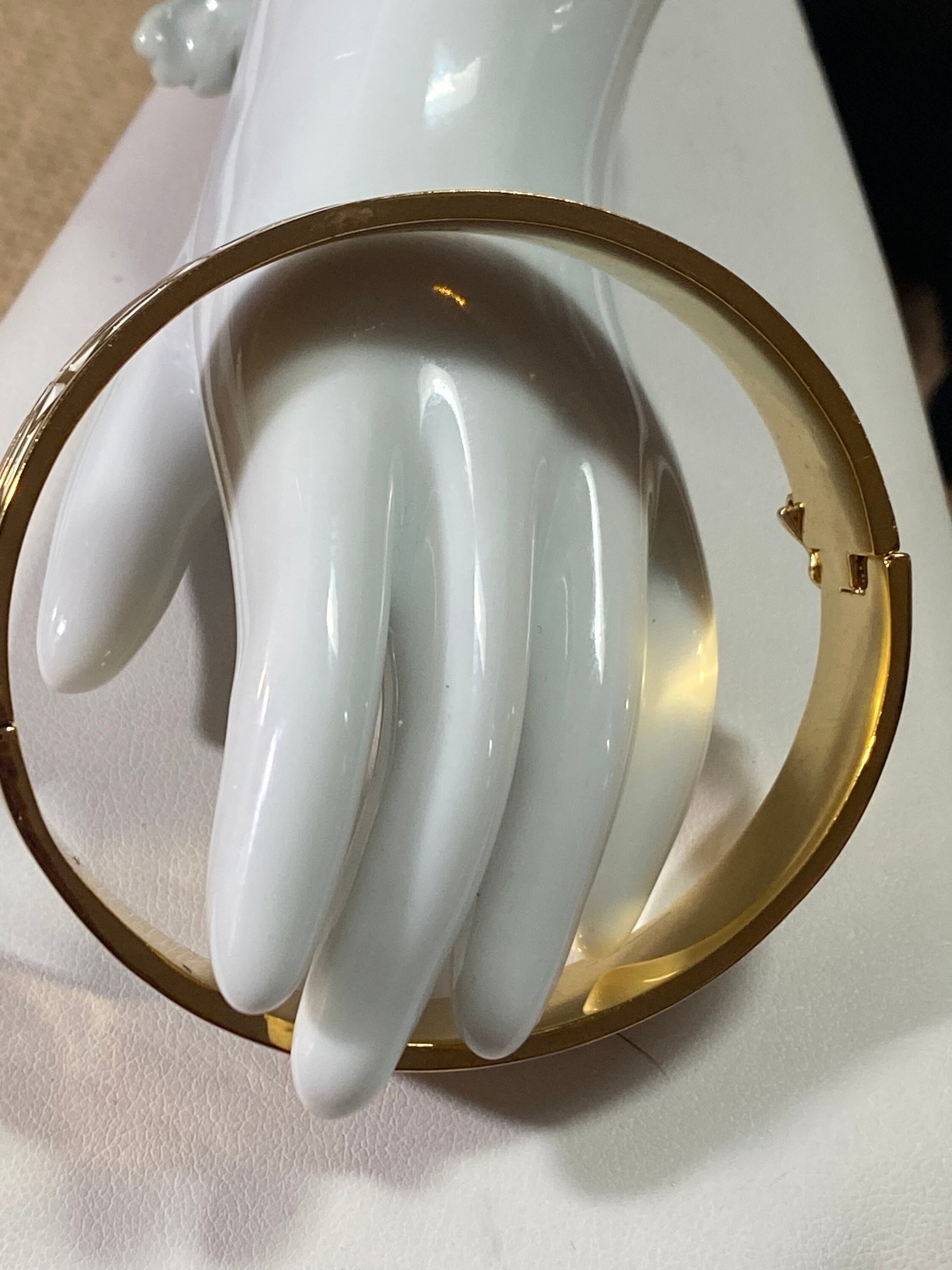Gold tone with white enameled pattern Stella & Dot Bangle bracelet