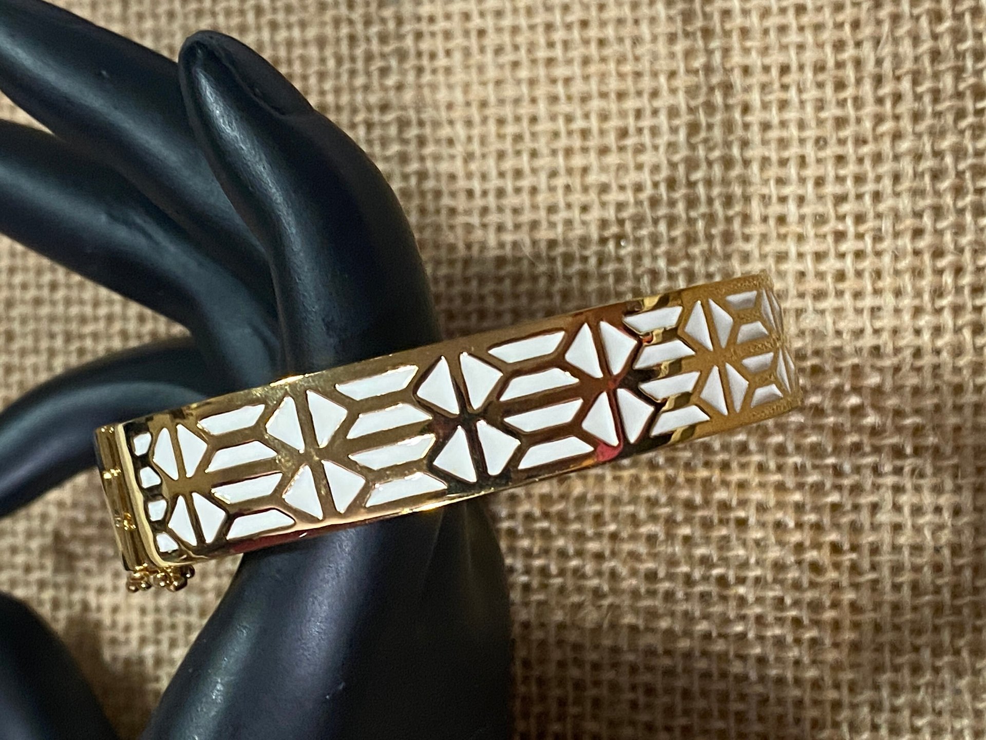 Gold tone with white enameled pattern Stella & Dot Bangle bracelet