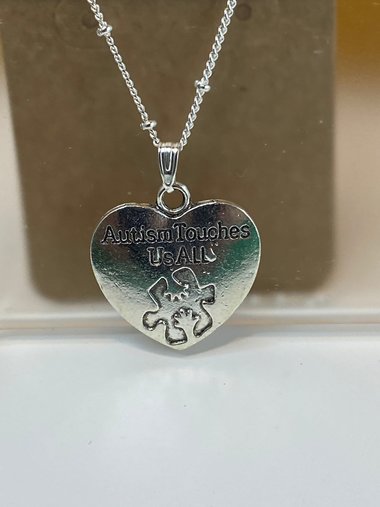 Silver necklace with Autism awareness message