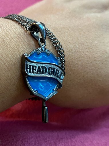 Head Girl pendant on black necklace