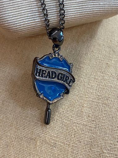 Head Girl pendant on black necklace