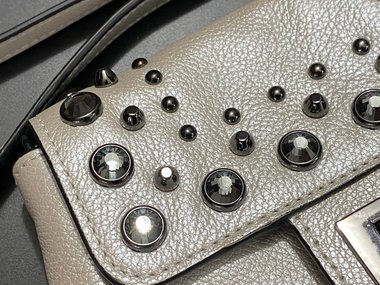 Bejeweled  Juicy Couture white with silver tone chain and dark stone