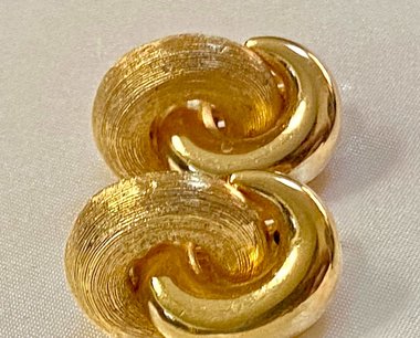 Vintage Gold tone 1980s Christian Dior high polished and textured clip on earrings.