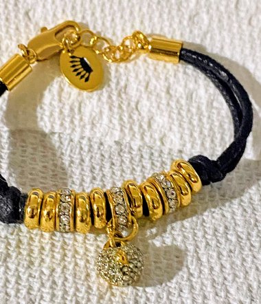 Juicy Couture Rhinestones pave pendant with Gold tone high gloss beads on black cord accent.